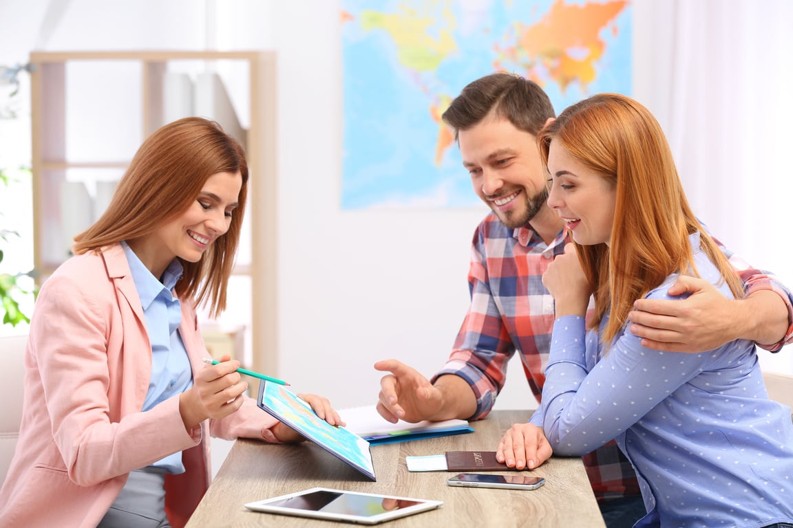 Female Manager Consulting Couple in Travel Agency